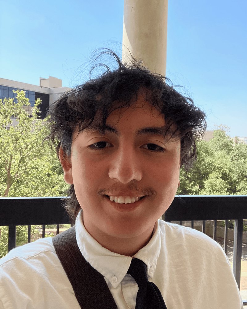 Rogelio Atilano-Hernandez III smiling on a balcony